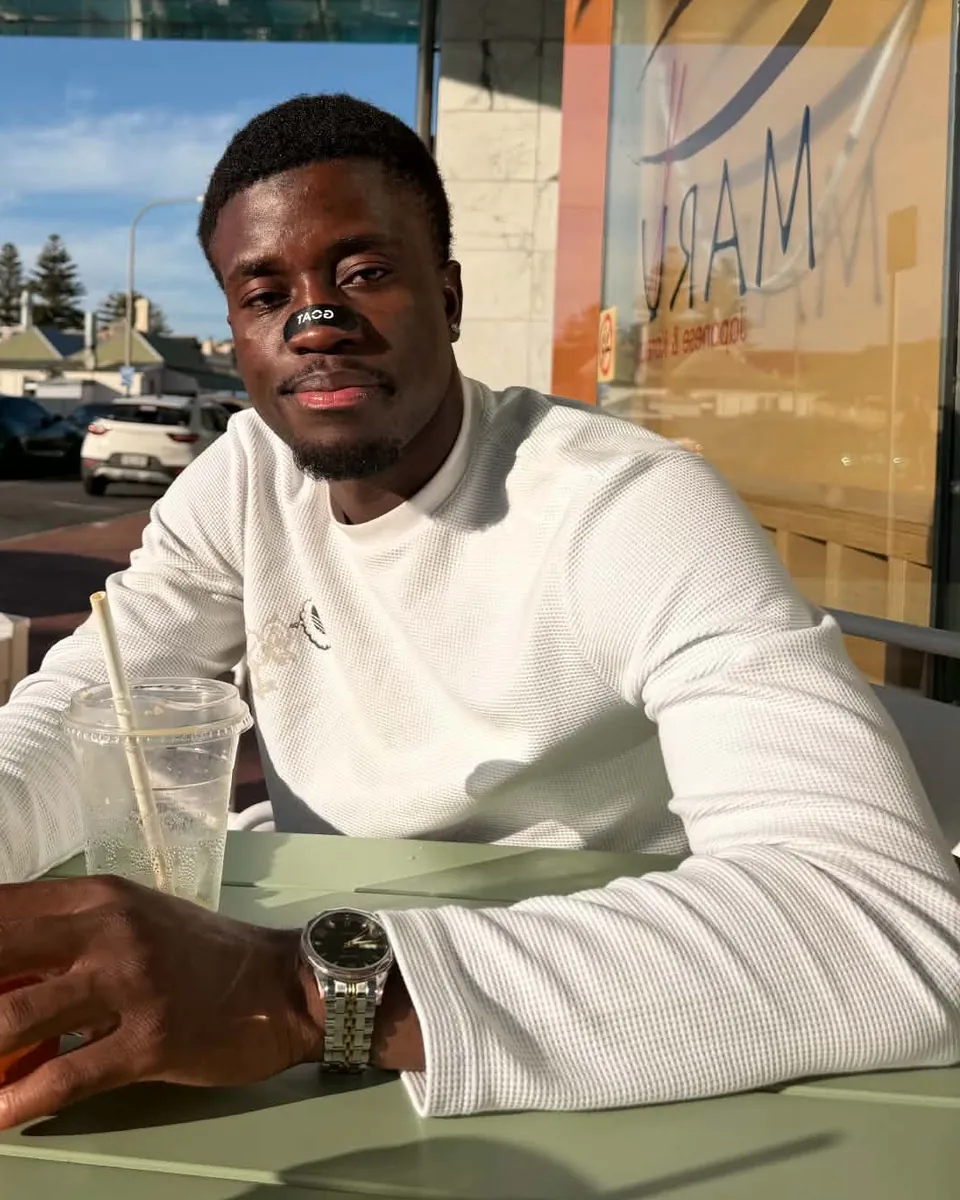 Enock Ipassou at an outdoor cafe table